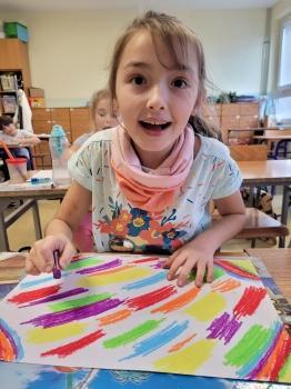 Dziewczynka maluje wskazane kolory