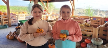 Dziewczynki trzymają ozdobione dynie